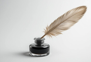Feather quill pen and glass inkwell isolated on a white background