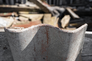 Old and very dangerous asbestos roof. Asbestos dust in the environment. Asbestos removal