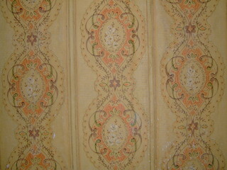 Decorative wallpaper showcasing intricate floral patterns with vibrant colors in a vintage style from a bygone era