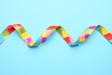 colorful ribbon with puzzle pieces on a blue background