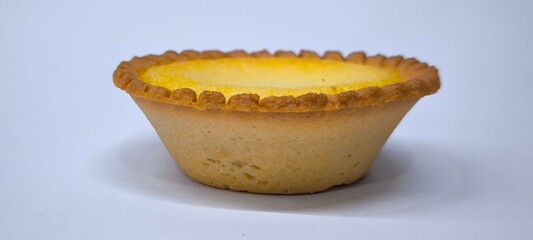 Egg tarts that are crispy on the outside and soft on the inside. Egg tarts that have a rich and creamy egg aroma. Egg tarts on white background.