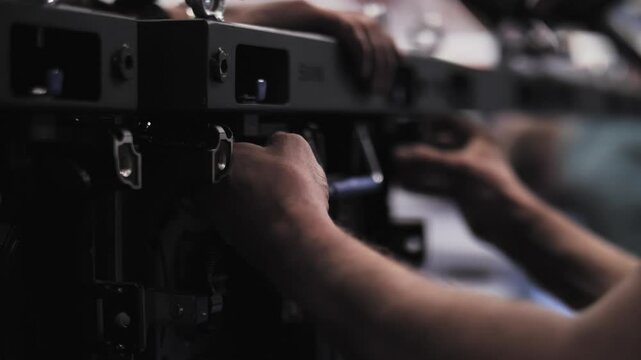Technician installing modular LED display panels