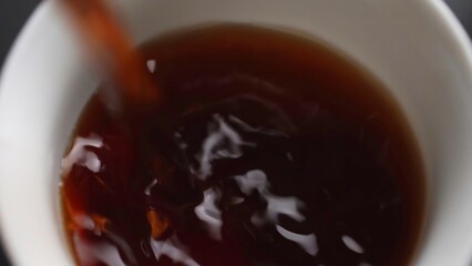 Carefully pouring a delicious beverage into a cup, creating an inviting and cozy atmosphere. Media