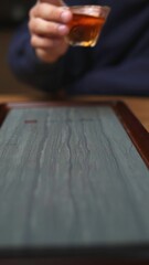 An Intimate CloseUp of a Beautiful Tea Cup Brimming with Rich Amber Liquid Inside. Media