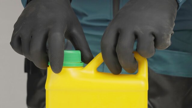 A man in black gloves pours bleach into a container, raising suspicions. Creative