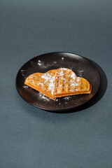 heart shaped waffles on a dark plate. Waffle day. baked waffles
