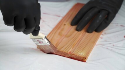 Meticulously Painting a Wooden Surface with Careful Attention to Detail and Protection. Creative