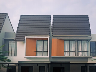 Modern minimalist house facade with clean lines, large windows, and soft daylight, ideal for real estate, architecture, and residential design visuals.


