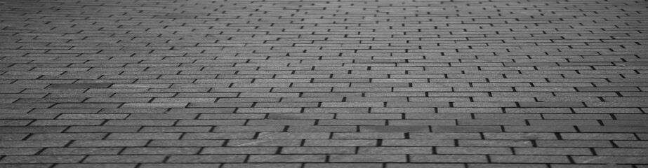 grey gray texture of a stone old monotonous pavement with a perspective. Exterior surface floor pattern. Urban street  flooring tiles, construction background.  Prospect.