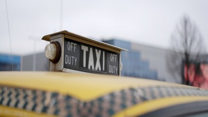Yellow taxi sign showing off duty status. Action