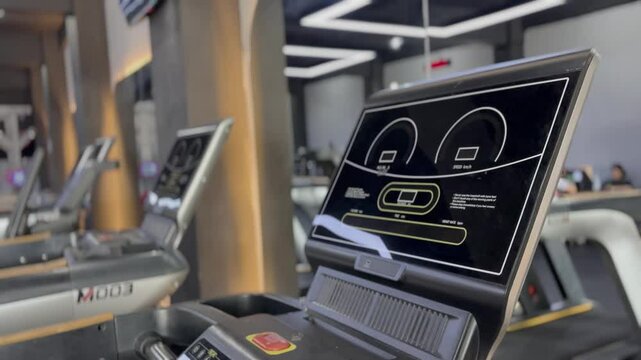 View of treadmills lined up in a modern gym, offering a diverse range of exercise options to enhance overall well-being and promote a healthy lifestyle, sports training and cardio workout.