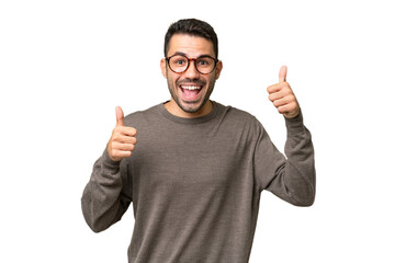 Young handsome caucasian man over isolated background giving a thumbs up gesture