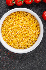 Pasta raw coquillette macaroni dish organic product fresh tasty gourmet food background on the table rustic food top view copy space