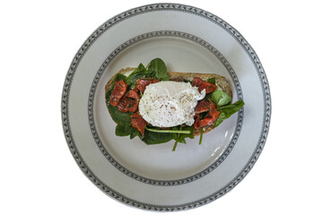 delicious breakfast poached egg on a slice of ciabatta with spinach and pieces of red salted fish, isolated on transparent background, png