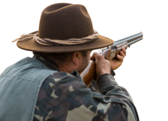 Hunter man in camouflage with a gun during the hunt in search of wild birds or game. Autumn hunting season.