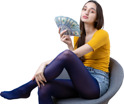Photo of a wealthy woman in simple clothes holding a fan of dollar money isolated against a concrete wall background