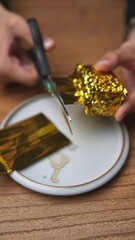Engaging in the creative crafting process using gold foil alongside a pair of scissors. Media
