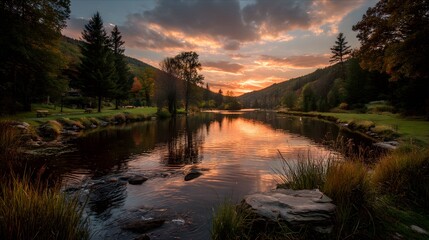 Obraz premium Romantischer Sonnenuntergang über ruhiger Flusslandschaft mit Bergen 