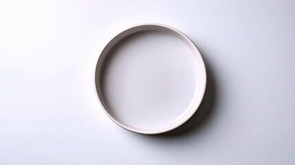 Minimalist Round Ceramic Plate Top Down View on White Background