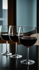A Trio of Temptations: Three Glasses Filled with Rich Red Wine, Ready for an Elegant and Relaxing Evening.