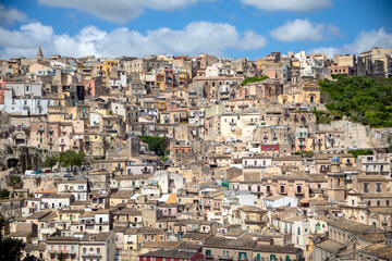 Naklejka premium View of part of the historic center of the city of Ragusa, Sicily, Italy, with its houses cascading over a hill, a city declared a UNESCO World Heritage Site
