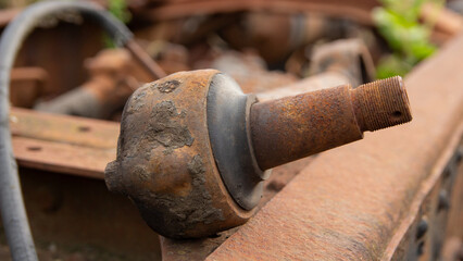 Close-up of a heavily rusted ball joint with a threaded stud. A steering or suspension component from a car.