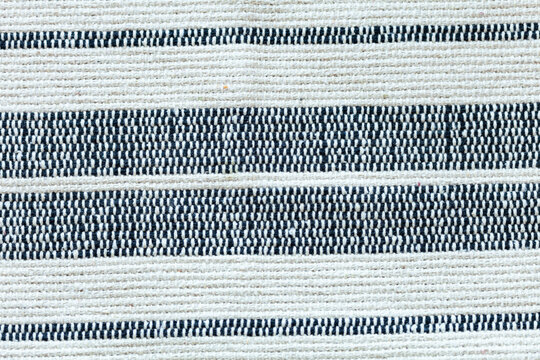 A close-up of fabric with horizontal stripes of contrasting colors, creating a textured and patterned surface. Great for backgrounds.