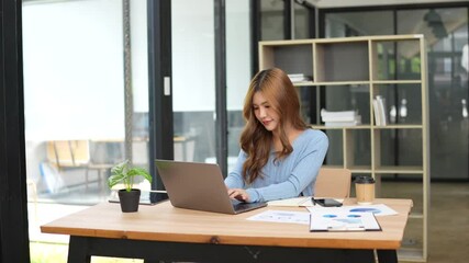 Asian businesswoman professional marketing manager using laptop working on computer to manage digital data and sitting in office - Powered by Adobe