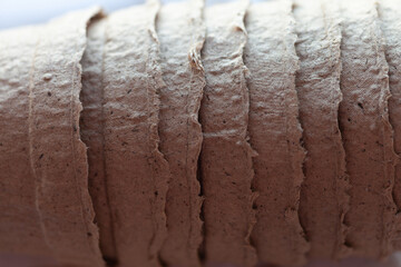 Fototapeta premium Close-up of stacked brown fiber seed starting pots, highlighting their texture and eco-friendly construction for plant propagation.