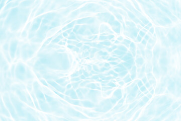 Blue water with ripples on the surface. Defocus blurred transparent blue colored clear calm water surface texture with splashes and bubbles. Water waves with shining pattern texture background.