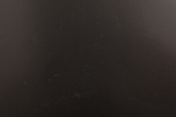 Scratched black surface texture background

