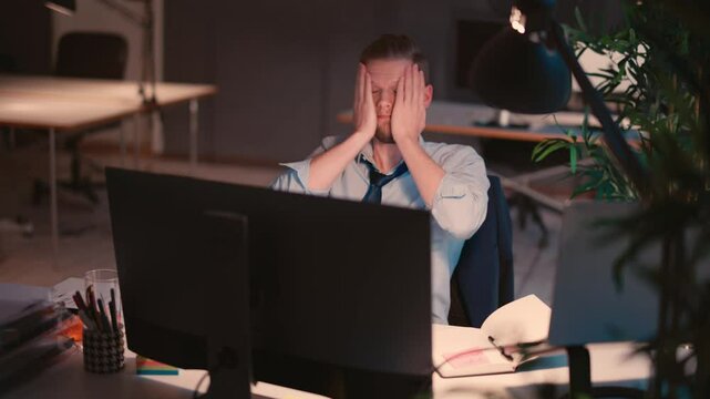 Man Working on Computer in a Modern Office Environment