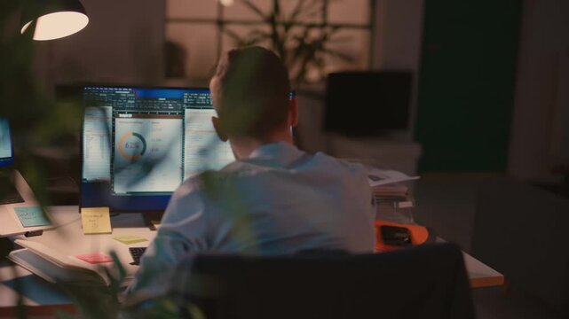Man Working on Computer in a Modern Office Environment