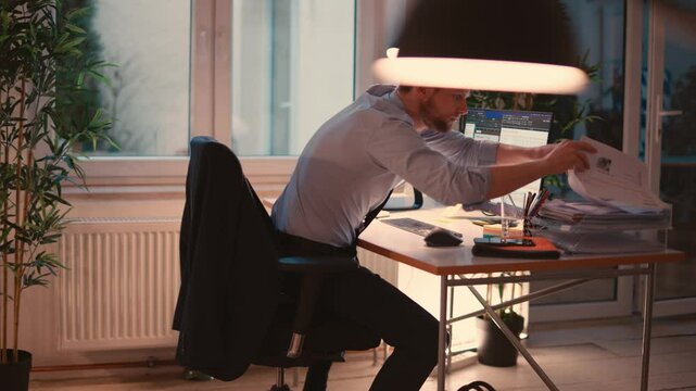 Man Working on Computer in a Modern Office Environment