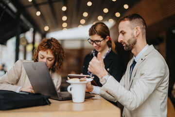 A group of professional entrepreneurs collaborates on a project while working at an outdoor cafe, embodying teamwork and productivity.
