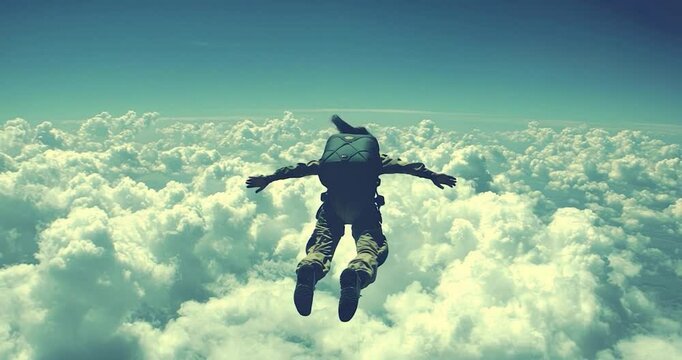 Skydiver above clouds