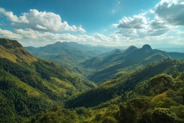 Obraz premium Serene Landscape of Lush Green Mountains Under Clear Blue Sky with Soft Clouds and Sunlight Over the Hills in Peaceful Natural Environment