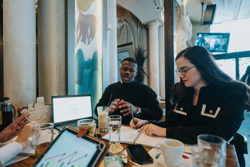 Multiracial coworkers brainstorming and sharing innovative ideas at a professional yet casual environment.