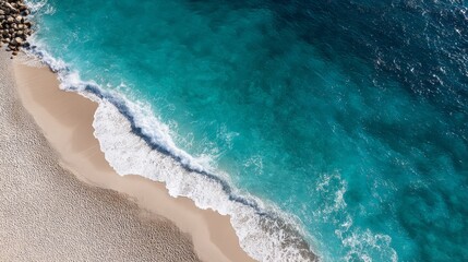 A calm shoreline features soft beige sand blending with gentle turquoise waves, creating a serene coastal landscape with ample space for design elements