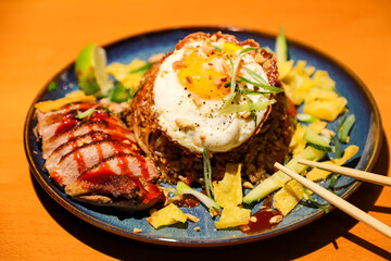 Traditional classic Asian dish Nasi Goreng in one of the Asian restaurants, consisting of fried rice and other ingredients.