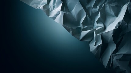 Dynamic folds of crinkled matte black paper showcase sharp lines and deep shadows, offering a unique backdrop for creative projects or design work