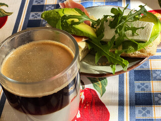 Coffee with milk and avocado sandwich