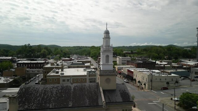 Aerial reveal past church steeple in town of Lenoir North Carolina