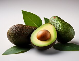 ripe avocados halved with seed and leaves on white background delicious healthy fruit