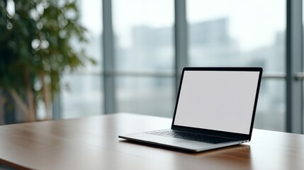 Fototapeta premium Wide-angle view of a sleek laptop on a glass desk showcasing a blank interface, ideal for remote collaboration, with a blurred plant backdrop