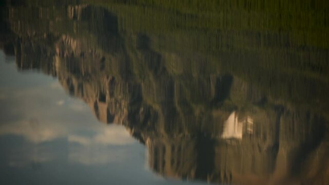 Reflection of Mountain in Rippling Water of Bowman Lake in Glacier National Park