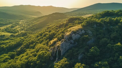 Verdant mountainside with cascading waterfall and lush trees