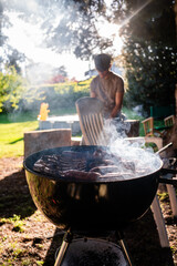 Grilling barbecue in a backyard on a sunny day