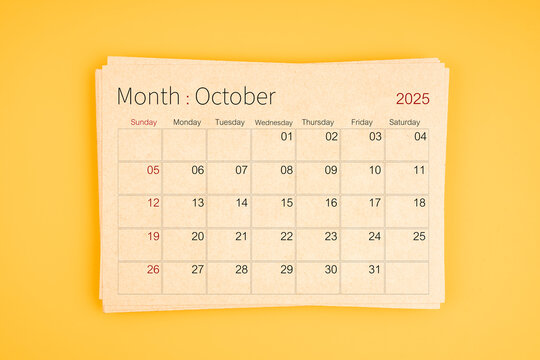 October 2025 calendar from brown recycle paper on yellow background.