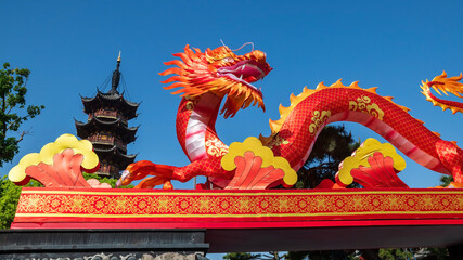 Red dragon and Longhua temple pagoda in bue sky, Shanghai, China